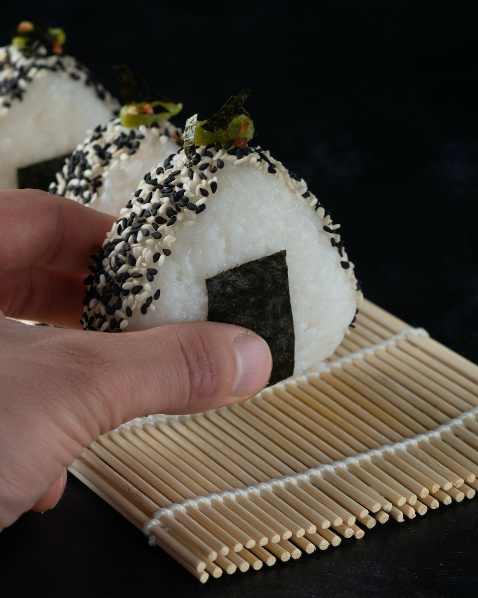 person holding white and brown cake