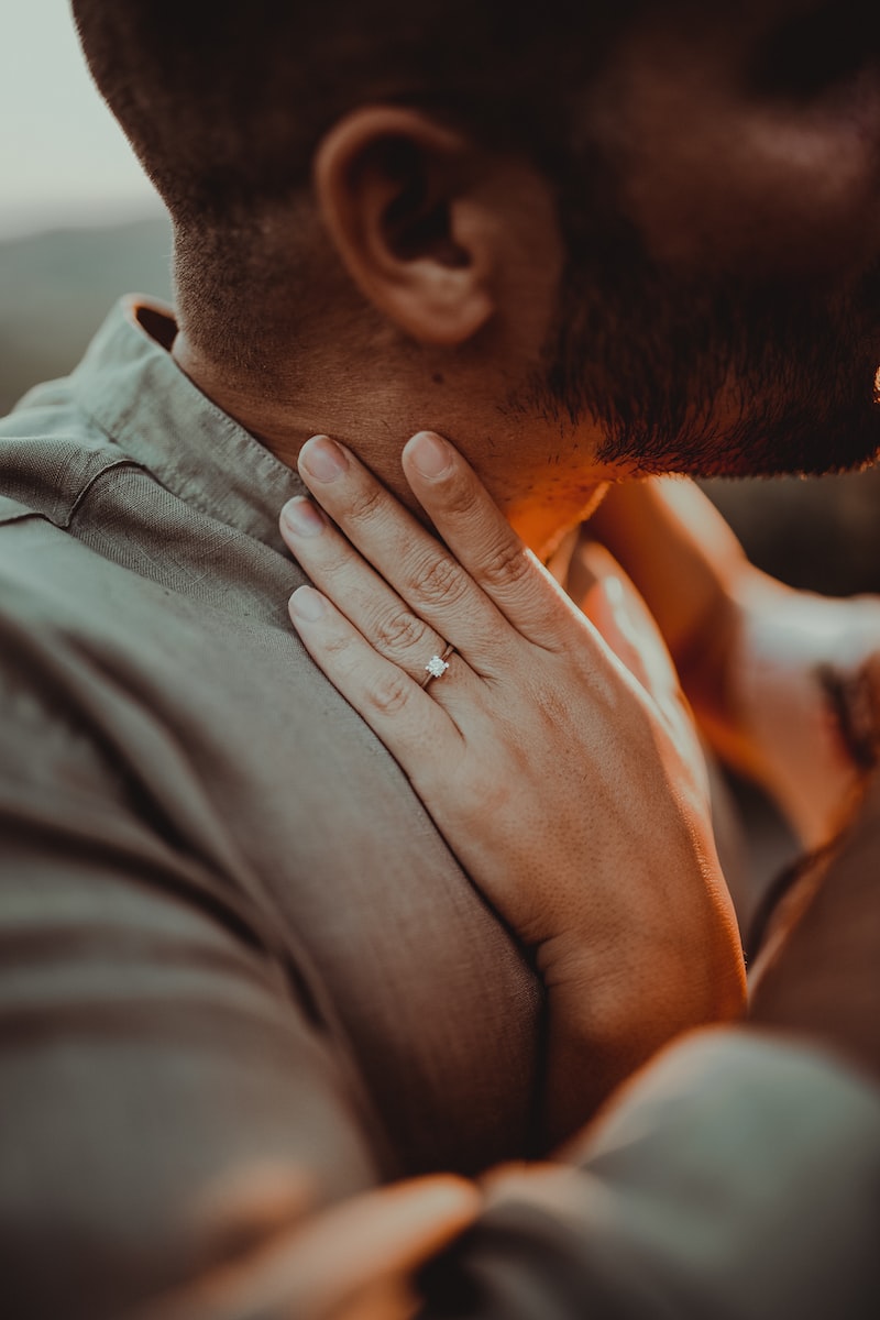 a close up of a person with a ring on their neck